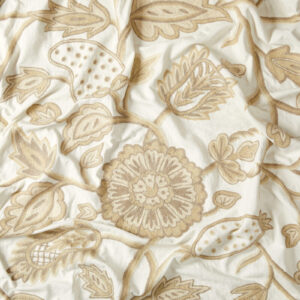 Crewel fabric. Cream cotton background with trailing floral embroidery in shades of taupe and cafe au lait.