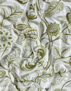 Green and cream fabric, hand embroidered in a floral design.